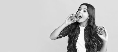 happy child eating sweet glazed donut, yummyの写真素材