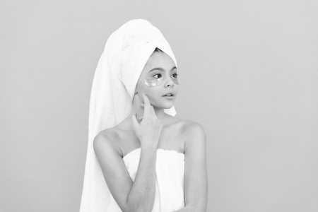 teen girl in shower towel with golden patchの写真素材