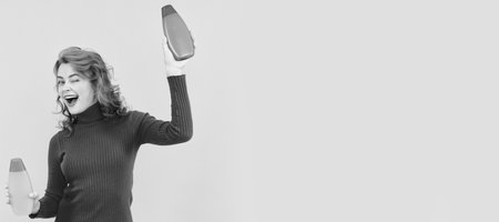 Woman isolated face portrait, banner with copy space. redhead lady presenting cosmetic product. happy woman use shower gel. funny girl curly hairの写真素材