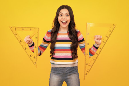 Amazed teenager. Teenager school girl study math or geometry lesson, measure the size. Mathematics...