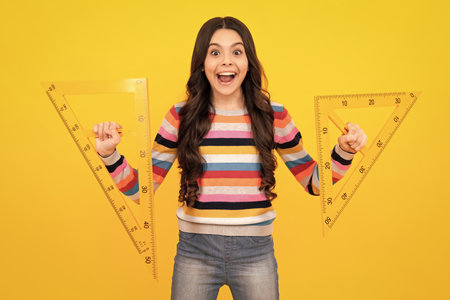 Amazed teenager. Teenager school girl study math or geometry lesson, measure the size. Mathematics ruler for measuring. Excited teen schoolgirl.の写真素材