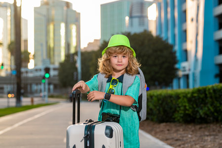 Child with travel suitcase. Kid and luggage for vacation, child trip. Little tourist with travel bag. Child traveler and baggage. Kid with luggage bags going on holiday trip.の写真素材