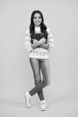 Back to school. Portrait of teenage school girl with books. Children school and education concept. Schoolgirl student.の写真素材