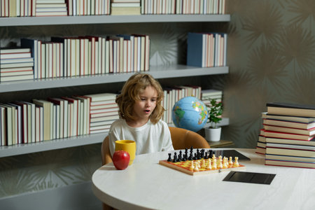 Chess school. Kid think about chess game in classroom. Child education concept. Intelligent, smart and clever school kids.の写真素材