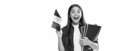 amazed kid hold french flag and school copybook for studying isolated on white. Portrait of schoolgirl student, studio banner header. School child face, copyspace.の写真素材