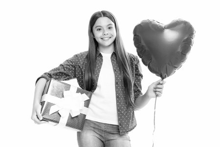 Child 12, 13, 14 years old with gift on isolated white background. Birthday, holiday concept. Teenager hold present box. Portrait of happy smiling teenage child girl.の写真素材
