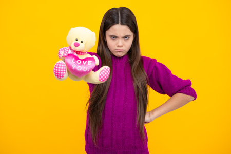 Childhood, toys and kids. Cute teen girl cuddling fluffy toy. Angry teenager girl, upset and unhappy negative emotion.の写真素材