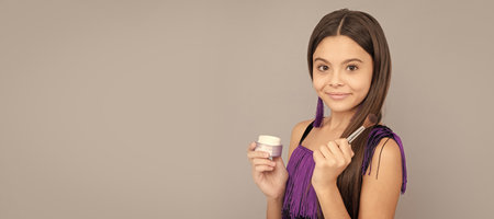 Beauty is all about you. Make-up girl grey background. Teenager cosmetics. Facial cosmetics. Cosmetics for teenager child, poster design. Beauty kids makeup, banner with copy space.の写真素材