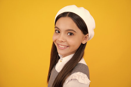 Portrait of cute positive little girl isolated on yellow background. Attractive caucasian child smiling and looking at camera. Happy face, positive and smiling emotions of teenager girl.の写真素材