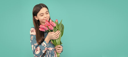 floral present. happy child smell tulips. mothers or womens day. Banner of spring child girl with tulips flowers bouquet, studio portrait with copy space.の写真素材
