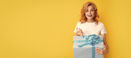 surprised redhead girl open gift box. boxing day. Beauty woman isolated face portrait, banner with mock up copy space.の写真素材