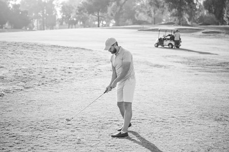 bearded man playing golf game on green grass, hobbyの写真素材