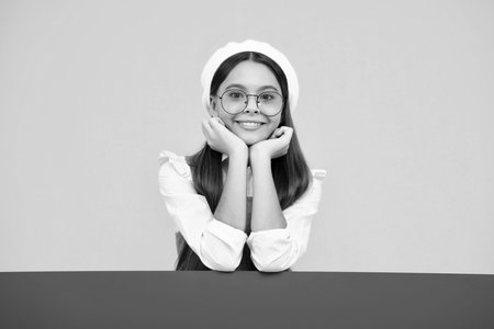 Teenage girl holds a blank for notification informing. Advertisement and sale. Markets and shops sales concept, blank board for copy space. Happy face, positive and smiling emotions of teenager girl.の写真素材