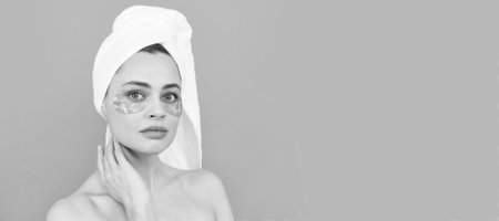 Eye patches, patch under eyes. shine future. skincare. facial collagen cosmetic. moisturizing skin. cosmetology. young woman. Beautiful woman isolated face portrait, banner with mock up copy space.の写真素材