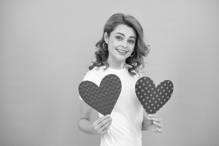 cheerful young lady with red heart on blue backgroundの写真素材