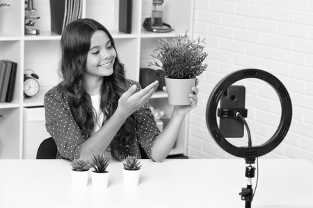 Young blogger girl recording video for blog. Teen girl speaking in front of camera for vlog....