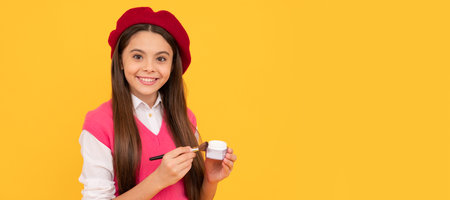 happy french teen girl hold powder brush. childhood happiness. skincare and makeup. Cosmetics for teenager child, poster design. Beauty kids makeup, banner with copy space.の写真素材