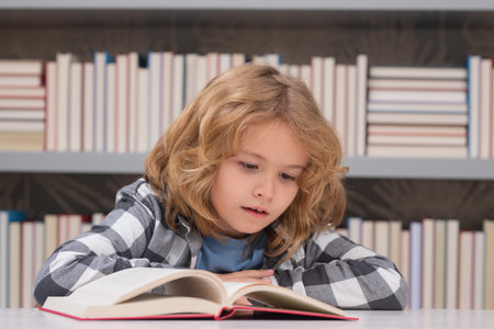 Child reading book in a book store or library,の写真素材