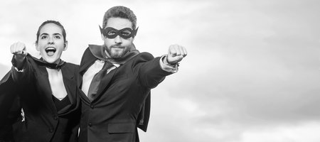 business couple in superhero suit on sky background. copy space. Horizontal poster design. Web banner header, copy space.の写真素材