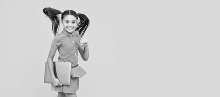 on way to success. back to school. modern digital communication. School girl portrait with laptop, horizontal poster. Banner header with copy space.の写真素材