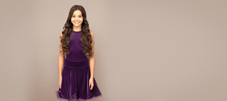 happy kid with long curly hair in dance ballroom dress full length, ballroom. Child face, horizontal poster, teenager girl isolated portrait, banner with copy space.の写真素材