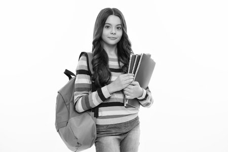 School teenager child girl with school backpack hold book and copybook. Teenager student, isolated background. Learning and knowledge. Go study.の写真素材