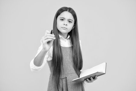 Teenager school girl study with books. Learning knowledge and kids education concept. Thinking teenager schoolgirl, thoughtful emotion.の写真素材