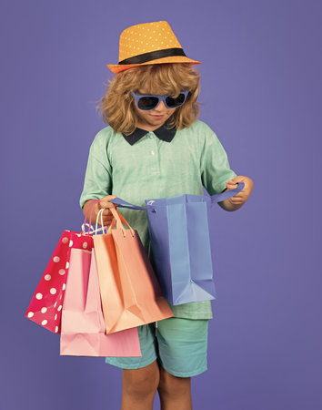Child with shopping bag in studio. Little shopper kid.の写真素材
