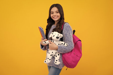 Happy teenager portrait. School teenager child girl with backpack hold toy. Fun study. Happy teenager, positive and smiling emotions of teen girl.の写真素材