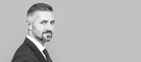 Man face portrait, banner with copy space. mature ambitious man businessman in businesslike suit has grizzled hair, success portrait.の写真素材