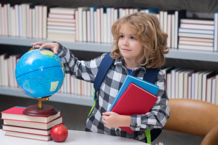Child from elementary school with book. Little student, clever nerd pupil ready to study. First time to school. Concept of education and learning.の写真素材