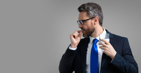 Tired man having a terrible headache. Exhausted man feeling unhealthy, upset about headache illness. Stressed middle-aged man having headache, banner with copy space. Migraine concept.の写真素材