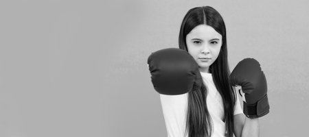 knockout. power and authority. teen girl in sportswear boxing gloves. sport challenge. punching. Horizontal poster of isolated child face, banner header, copy space.の写真素材