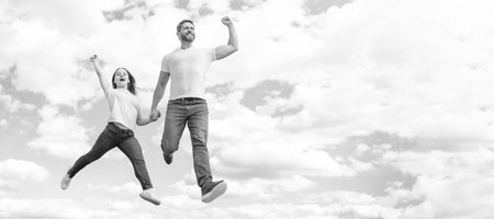 Father and daughter jump on sky, banner with copy space. happy father and daughter jump in sky. happinessの写真素材