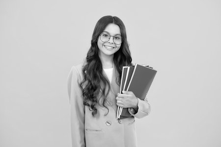 Teenager school girl with books isolated studio background.の写真素材