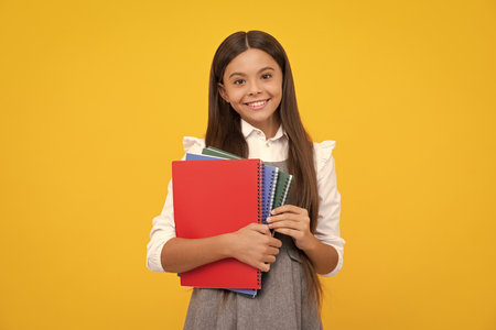 Teenager school girl study with books. Learning knowledge and kids education concept. Happy schoolgirl face, positive and smiling emotions.の写真素材