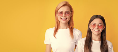Mother and daughter child banner, copy space, isolated background. cheerful kid and mom. mother and daughter in sunglasses. beauty and fashion.の写真素材