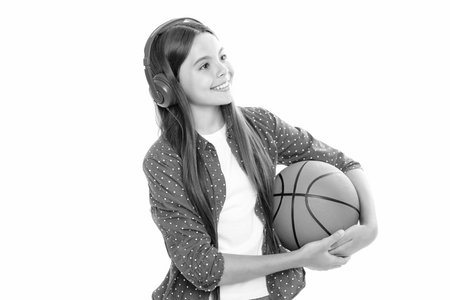 Young teenage child girl basketball player standing on white background.の写真素材