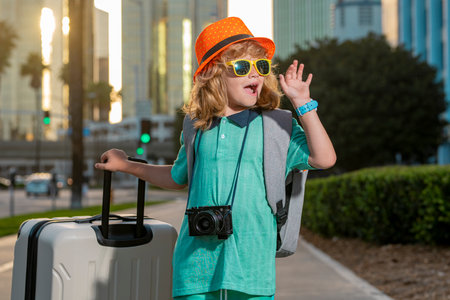 Little traveler tourist kid boy 7-8 years old. Passenger traveling abroad to travel on weekends getaway. Independent kid boy with big travel bag.の写真素材