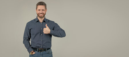 Showing approval or satisfaction. Happy man give thumbs up. Approval concept. Man face portrait, banner with copy space.の写真素材
