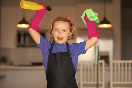 Cleaning house. Portrait of child helping with housework, cleaning the house. Housekeeping, home chores.の写真素材