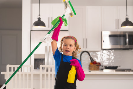 Housekeeping, home chores. Child mopping house, cleaning home. Detergents and cleaning accessories. Cleaning service. Little boy housekeeping.の写真素材