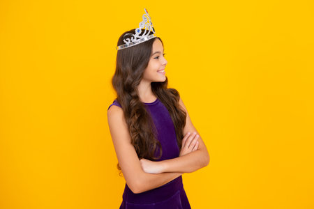 Beauty teen girl queen wear crown. Child in princess diadem. Happy girl face, positive and smiling emotions.の写真素材