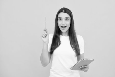 Student inspiration creativity, solution. Eureka, idea. Portrait of excited young woman having wow creative idea, studio background, copyspace.の写真素材