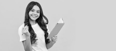 student prepare for exam. schoolgirl do homework. making notes. pupil writing in planner. Horizontal isolated poster of school girl student. Banner header portrait of schoolgirl copy space.の写真素材