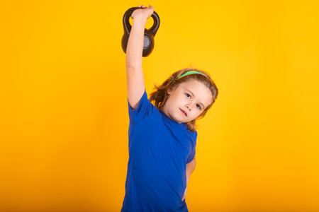 Kid boy working out with dumbbells. Sport and kids training.の写真素材
