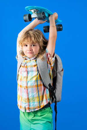 Child with skateboard in the studio. Kid having fun with penny board. Penny board, skateboard for children. Longboard, skateboard skate board concept.の写真素材