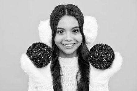 Merry christmas and happy New year. Kid in winter clothes. Teen girl with decorative christmas ball.の写真素材