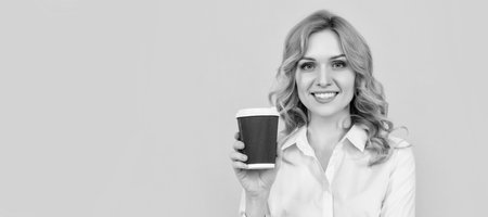 Woman with coffee cup. smiling blonde woman with coffee cup on yellow background. Woman isolated face portrait, banner with mock up copy space.の写真素材