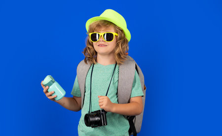 Child with camera. Kids travel and adventure concept. Child photographer with camera.